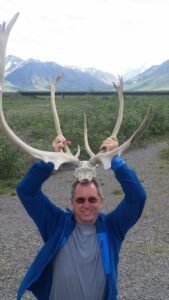Randy in Alaska holding antlers on his head