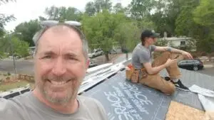 Randy and Ross roofing a house