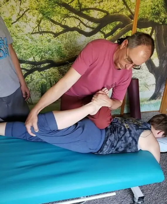 Randy teaching class to massage therapists on how to perform sports stretching