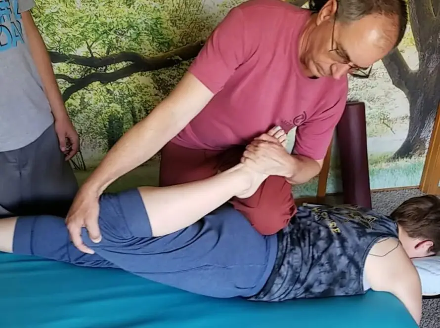 Randy teaching class to massage therapists on how to perform sports stretching