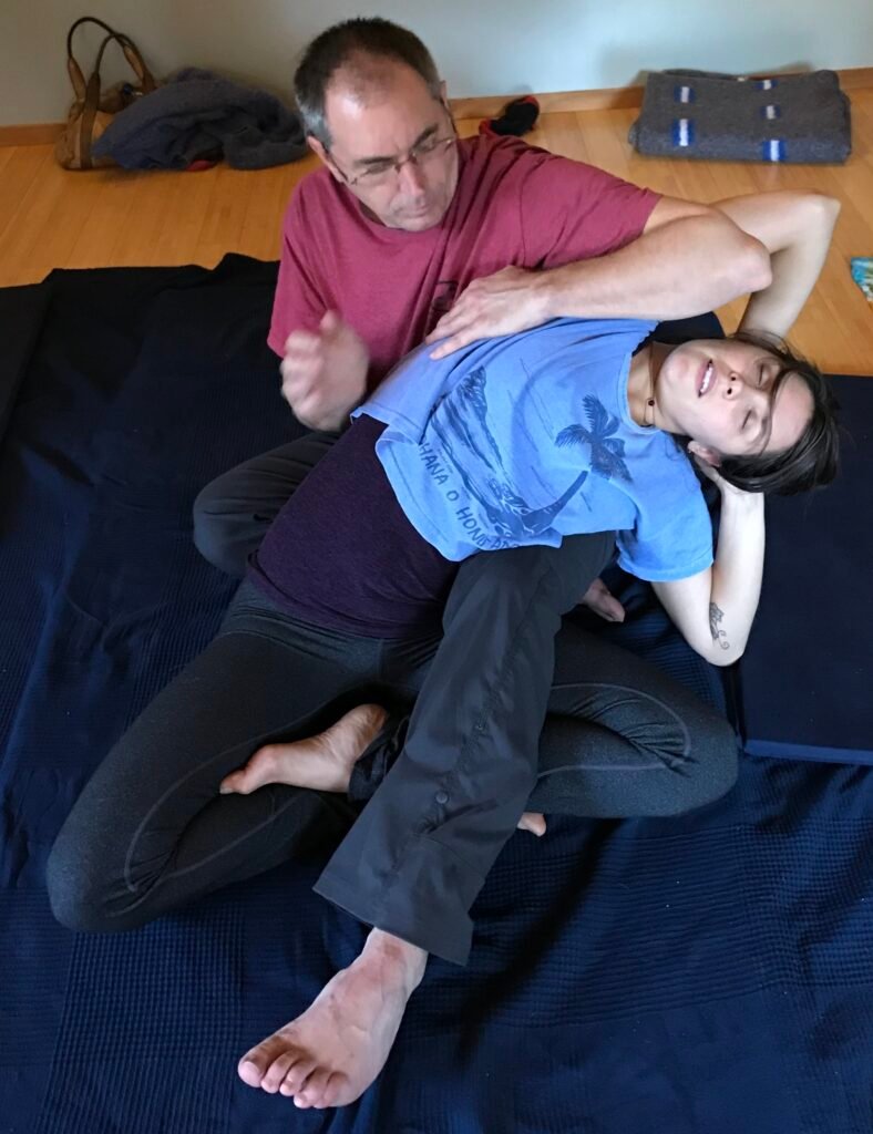 Randy side bending a client in a Thai massage stretch